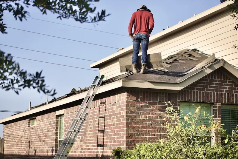 Professional roofer working on a residential roof in Pebblecreek